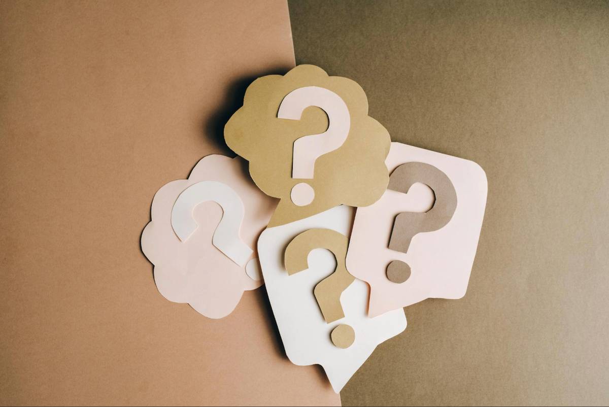 paper cutouts of question marks symbolizing reflection and problem solving