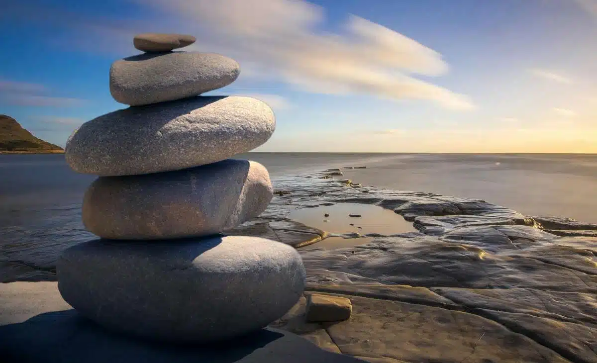 Balanced stack of smooth stones by the sea symbolizing mindfulness and inner peace