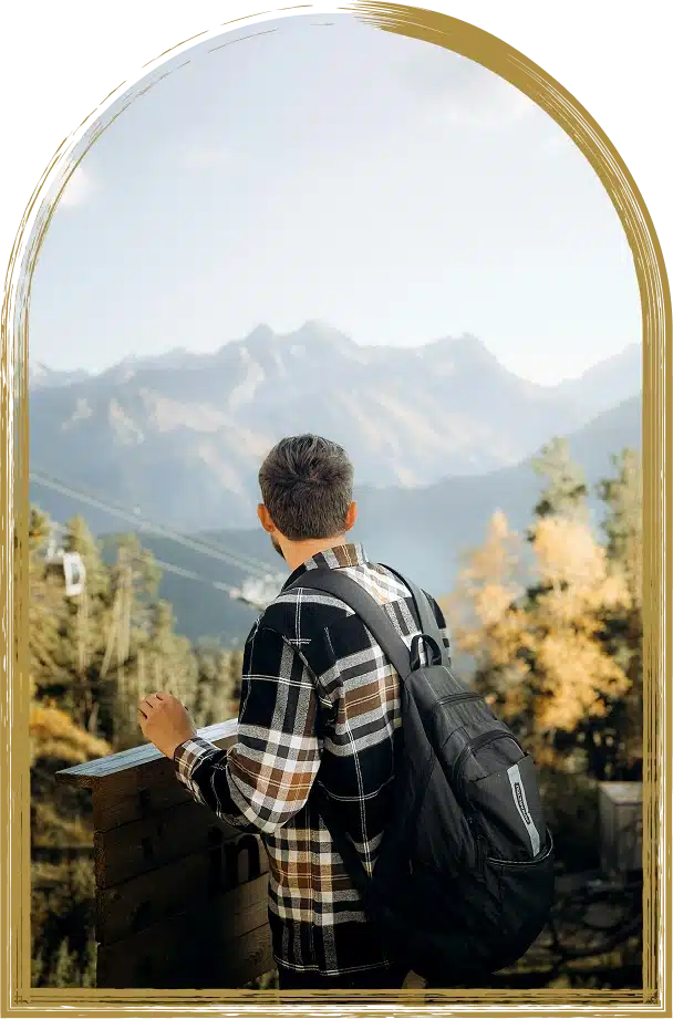 Man with backpack viewing mountains.